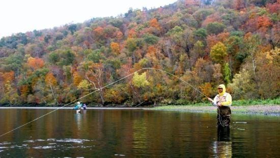 Matthew Davies image of a man fishing from the water.