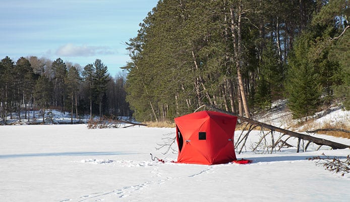 Matthew Davies image of an ice fishing hut out on the lake.