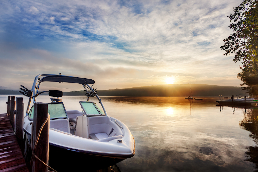 Matthew Davies image of a boat on the water in the early morning with steam coming off the lake